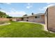 Expansive backyard features a lush lawn, covered patio, and mature landscaping, creating a serene retreat at 22 Jade Cir, Las Vegas, NV 89106