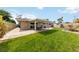 Landscaped backyard with manicured lawn, a covered patio and storage shed, perfect for outdoor enjoyment at 22 Jade Cir, Las Vegas, NV 89106
