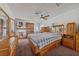Spacious bedroom with wood furnishings, neutral carpet, and a ceiling fan at 22 Jade Cir, Las Vegas, NV 89106