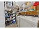 Well-equipped laundry room with a washer, dryer, shelving, and ample storage space at 22 Jade Cir, Las Vegas, NV 89106