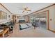Bright living room featuring plush seating, a ceiling fan, and access to the covered patio at 22 Jade Cir, Las Vegas, NV 89106