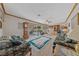 Cozy living room with floral furniture, ceiling fan, and sliding glass doors to the backyard at 22 Jade Cir, Las Vegas, NV 89106