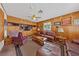 Cozy living room featuring wood paneling, built-in cabinets, and comfortable seating at 22 Jade Cir, Las Vegas, NV 89106