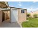 Exterior view of the storage shed on the property with grass and landscaping surrounding it at 22 Jade Cir, Las Vegas, NV 89106