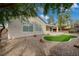 The well-maintained backyard features artificial turf, decorative rock, and a covered patio for outdoor living and relaxation at 2603 Savannah Springs Ave, Henderson, NV 89052