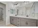 Modern bathroom featuring a dual sink vanity with sleek gray cabinets and a frameless glass shower at 2603 Savannah Springs Ave, Henderson, NV 89052