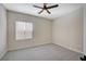 Carpeted bedroom featuring a modern ceiling fan and natural light from a window at 2603 Savannah Springs Ave, Henderson, NV 89052