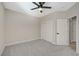 Spacious carpeted bedroom with a ceiling fan, double-door closet, and light-colored walls at 2603 Savannah Springs Ave, Henderson, NV 89052