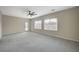 Bright bedroom with plush gray carpets, light-colored walls, and natural light from dual windows at 2603 Savannah Springs Ave, Henderson, NV 89052