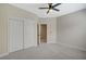Bright bedroom with ceiling fan, closet, and neutral carpeting at 2603 Savannah Springs Ave, Henderson, NV 89052