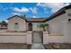 Front exterior features desert landscaping, rock ground cover, and a secure gated entrance for added curb appeal at 2603 Savannah Springs Ave, Henderson, NV 89052