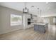 Well-lit kitchen with a large island and stainless steel appliances, open to the dining area at 2603 Savannah Springs Ave, Henderson, NV 89052