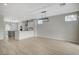 Open concept living area with modern light fixture adjacent to the gray and white kitchen at 2603 Savannah Springs Ave, Henderson, NV 89052
