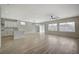 Open concept living and kitchen area with natural light, wood floors, and a ceiling fan at 2603 Savannah Springs Ave, Henderson, NV 89052