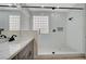 Glass enclosed shower features a rain shower head and decorative tiling at 2603 Savannah Springs Ave, Henderson, NV 89052