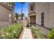 Exterior side view showing a walkway with flowers leading to the front entrance at 270 Snowy River Cir, Henderson, NV 89074