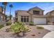 Charming two-story home with a well-maintained front yard, desert landscaping, and a two-car garage at 270 Snowy River Cir, Henderson, NV 89074