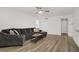 Spacious living room with a large comfortable couch and hardwood floors at 270 Snowy River Cir, Henderson, NV 89074