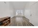 Spacious living area with wood-look floors, a front door, and lots of natural light from large windows at 270 Snowy River Cir, Henderson, NV 89074
