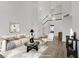 Bright, staged living room with high ceilings, neutral tones, modern decor, and wood-look floors at 270 Snowy River Cir, Henderson, NV 89074