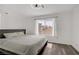 Bright main bedroom with a ceiling fan, wood floors and a large window overlooking the neighborhood at 270 Snowy River Cir, Henderson, NV 89074