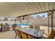 Covered patio area featuring comfortable seating and dining adjacent to a sparkling pool at 270 Snowy River Cir, Henderson, NV 89074