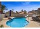Sparkling pool with slide and covered seating area in the backyard at 270 Snowy River Cir, Henderson, NV 89074