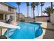 Cool off in this sparkling in-ground pool featuring a built-in slide and soothing blue water at 270 Snowy River Cir, Henderson, NV 89074