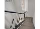 Bright staircase showcasing white wood risers with a contrasting black railing at 270 Snowy River Cir, Henderson, NV 89074