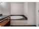 Modern bathroom with a built-in tub with black marble countertops at 2700 Las Vegas Blvd # 610, Las Vegas, NV 89109