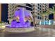 Close up of a condo building entrance with a cascading water feature and colorful accent lighting at 2700 Las Vegas Blvd # 610, Las Vegas, NV 89109