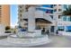 Grand high-rise entrance with circular driveway, valet parking, and lush landscaping at 2700 Las Vegas Blvd # 610, Las Vegas, NV 89109
