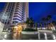 Valet entrance with circular drive, covered entry, lush landscaping, and modern design at 2700 Las Vegas Blvd # 610, Las Vegas, NV 89109