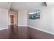 Bright living room with hardwood floors, TV, and entrance to Primary bathroom at 2700 Las Vegas Blvd # 610, Las Vegas, NV 89109