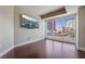 Spacious living room with hardwood floors, a large TV, and expansive windows with city views at 2700 Las Vegas Blvd # 610, Las Vegas, NV 89109