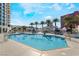 Community swimming pool surrounded by lounge chairs and palm trees at 2700 Las Vegas Blvd # 610, Las Vegas, NV 89109