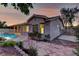 Beautiful backyard featuring a pool, a covered patio, and thoughtfully designed landscaping and stone pathway at 2725 Cool Lilac Ave, Henderson, NV 89052