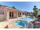 Backyard featuring a swimming pool and jacuzzi with covered patio at 2725 Cool Lilac Ave, Henderson, NV 89052