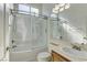 Bathroom with double vanity sinks, shower over tub, and bright lighting at 2725 Cool Lilac Ave, Henderson, NV 89052
