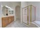 Spacious bathroom features dual vanities, walk-in shower with glass door and a soaking tub at 2725 Cool Lilac Ave, Henderson, NV 89052