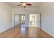 Bedroom with wood floors, an open doorway, and large mirrored closet doors at 2725 Cool Lilac Ave, Henderson, NV 89052