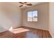 Bedroom with wood floors, ceiling fan, and large window at 2725 Cool Lilac Ave, Henderson, NV 89052
