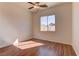 Bedroom featuring wood floors, ceiling fan and a bright window at 2725 Cool Lilac Ave, Henderson, NV 89052