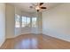 Bright bedroom featuring laminate flooring and ceiling fan with views from multiple windows at 2725 Cool Lilac Ave, Henderson, NV 89052