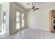 Breakfast nook featuring tile floors, ceiling fan and natural light from the french doors with view of the pool at 2725 Cool Lilac Ave, Henderson, NV 89052