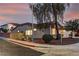 Corner lot home featuring desert landscaping, privacy fence, and a tile roof at twilight at 2725 Cool Lilac Ave, Henderson, NV 89052