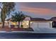 Charming single-story home featuring a two-car garage, desert landscaping, and a tile roof at sunset at 2725 Cool Lilac Ave, Henderson, NV 89052