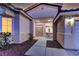 Inviting front entrance with double doors, a cozy sitting area, and well-manicured landscaping at 2725 Cool Lilac Ave, Henderson, NV 89052