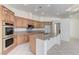 Bright kitchen boasts wood cabinets, granite countertops, stainless steel appliances, and a large island at 2725 Cool Lilac Ave, Henderson, NV 89052