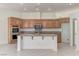 Well-appointed kitchen with wooden cabinets, granite countertops, stainless steel appliances, and center island at 2725 Cool Lilac Ave, Henderson, NV 89052